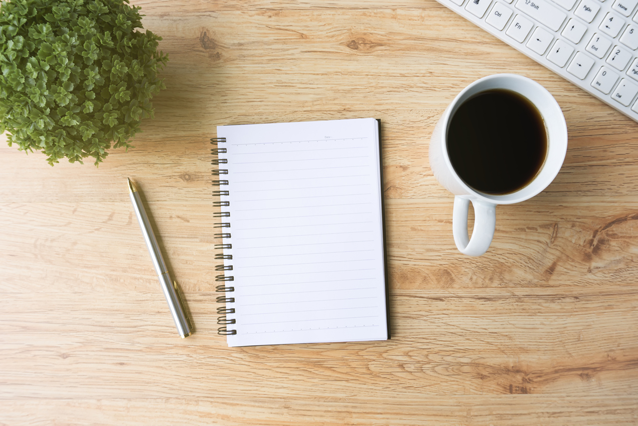 smartphone and other technology supplies with cup of coffee