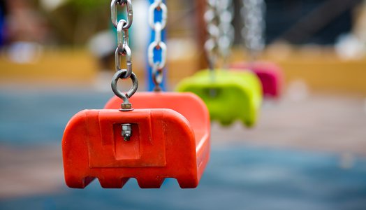Close up of empty swing in a playground